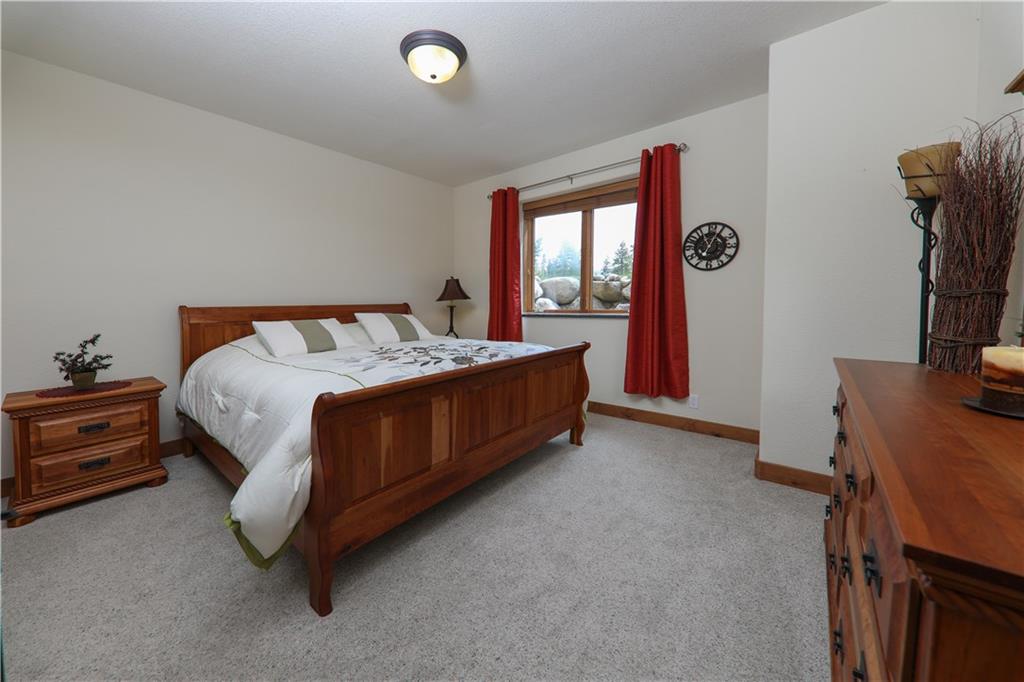 290 Elk Circle Keystone, CO 80435 - Photo 20 of 25 a bed sitting in a bedroom next to a window