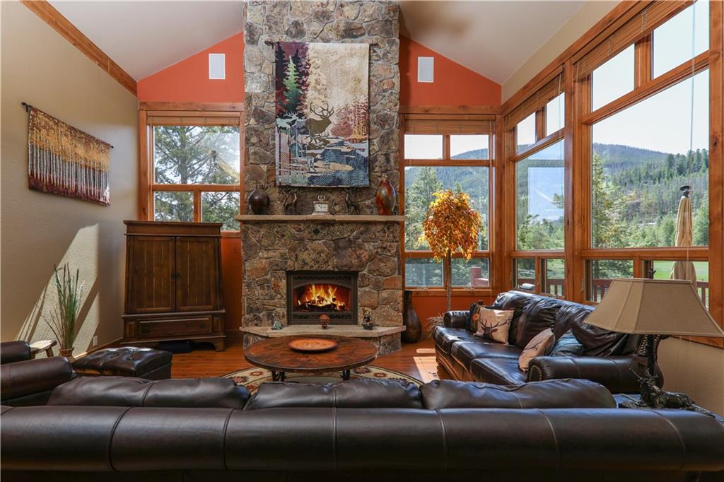 290 Elk Circle Keystone, CO 80435 - Photo 7 of 25 a living room with furniture a fireplace and floor to ceiling windows