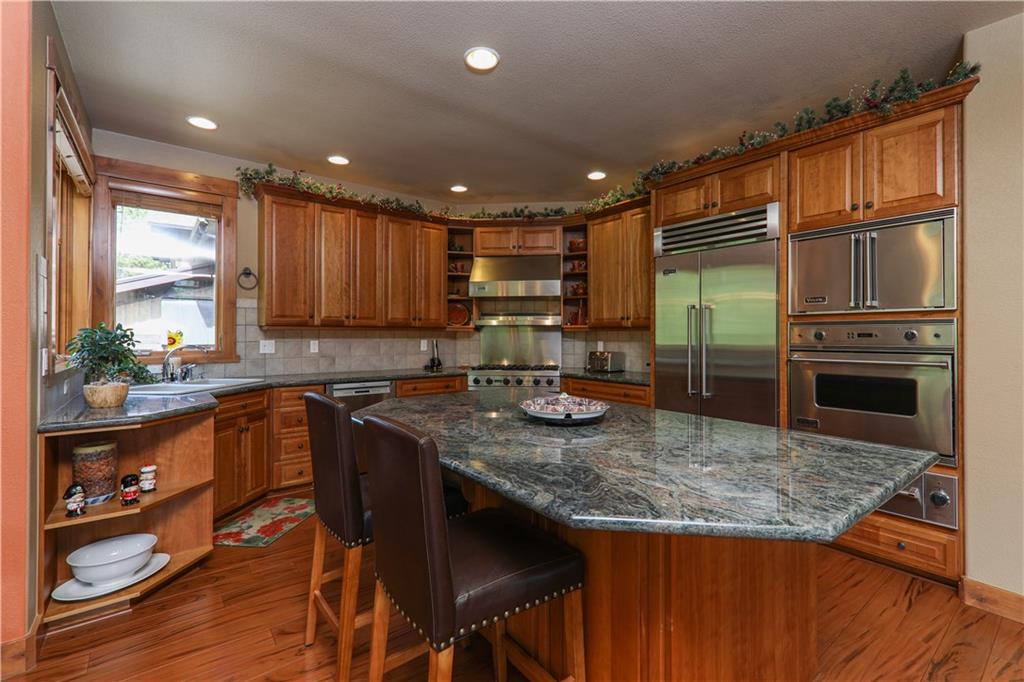 290 Elk Circle Keystone, CO 80435 - Photo 8 of 25 a kitchen with kitchen island granite countertop wooden cabinets and a refrigerator