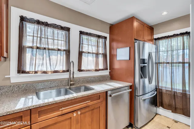 a kitchen with stainless steel appliances granite countertop a sink stove and cabinets