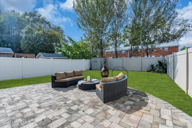 a view of a patio with couches and a fire pit