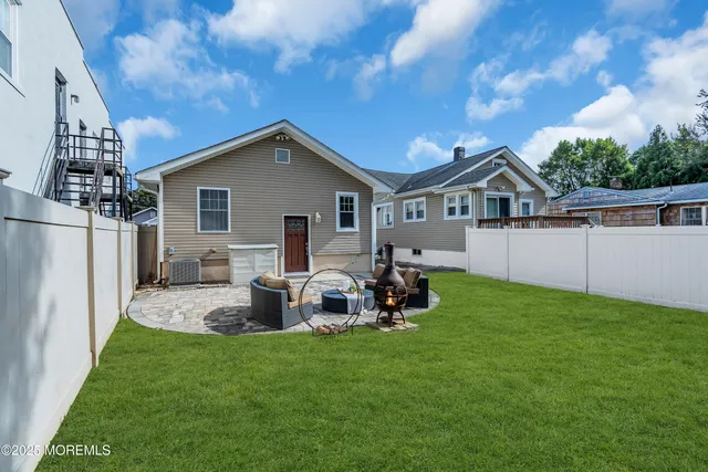 an aerial view of a house with a garden and lake view