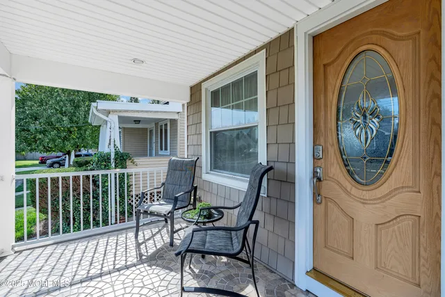 a view of a house with a chairs and wooden deck