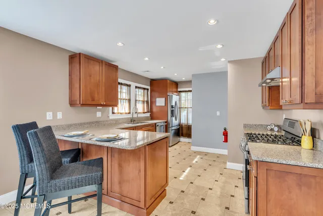 a kitchen with stainless steel appliances granite countertop a refrigerator and a sink