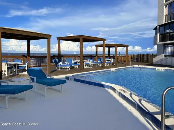 a view of a bench in the garden near a lake
