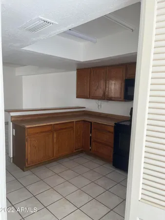 a kitchen with a cabinets and a refrigerator