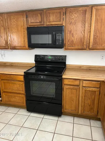 a kitchen with granite countertop cabinets and steel stainless steel appliances