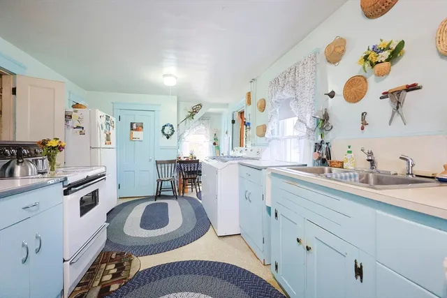 a kitchen with a sink stove and cabinets