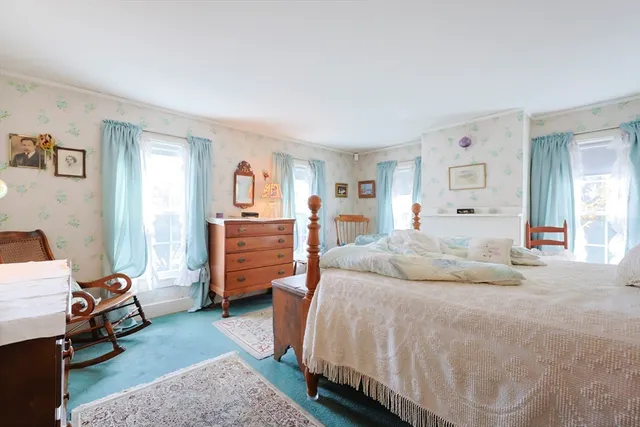 a white bath tub sitting next to a white toilet