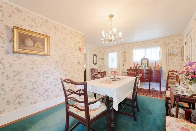 a view of a dining room with furniture and chandelier