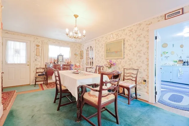 a view of a dining room with furniture and chandelier