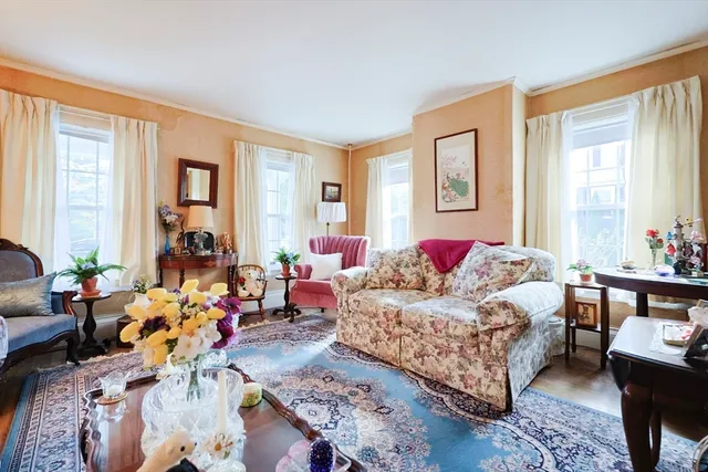 a bedroom with bed couch and window