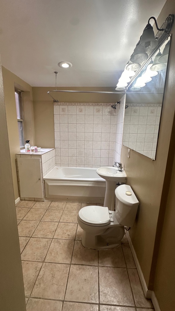 6714 South Chappel Avenue, Unit 2 Chicago, IL 60649 - Photo 5 of 10 a bathroom with a sink a toilet and a mirror