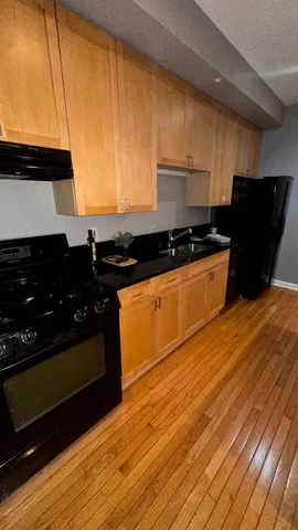 a kitchen with granite countertop a stove and a refrigerator