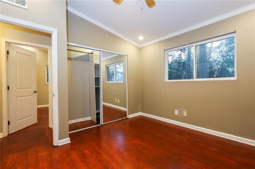 1277 Goodwin Road Northeast, Unit 1275 Atlanta, GA 30324 - Photo 11 of 19 an empty room with wooden floor and windows
