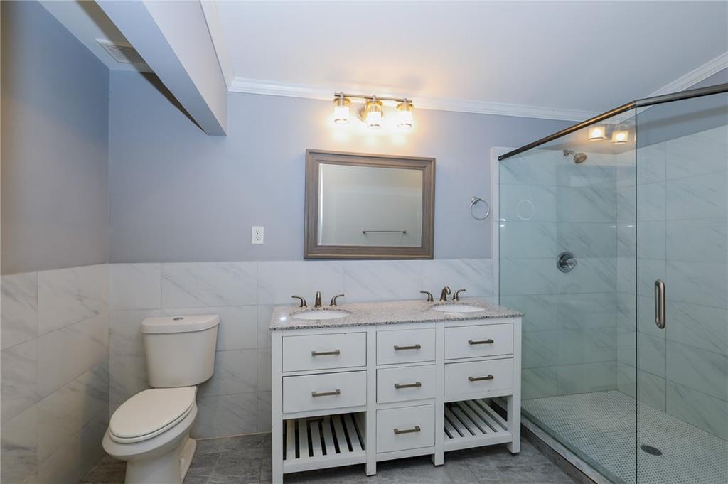 1277 Goodwin Road Northeast, Unit 1275 Atlanta, GA 30324 - Photo 16 of 19 a bathroom with a toilet sink and mirror
