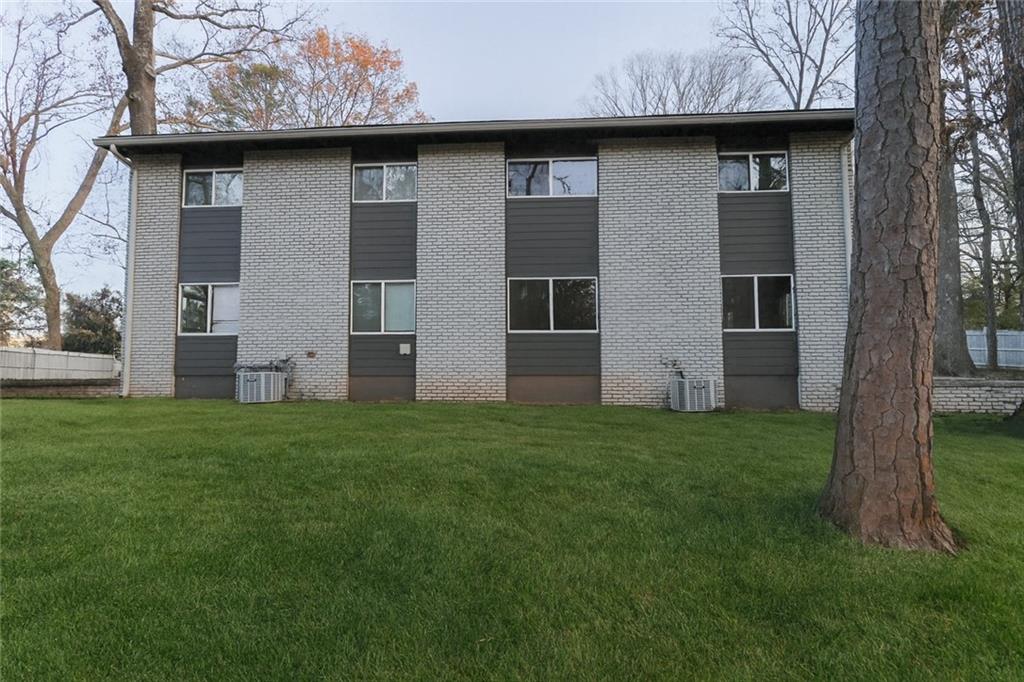 1277 Goodwin Road Northeast, Unit 1275 Atlanta, GA 30324 - Photo 17 of 19 a brick house with a small yard