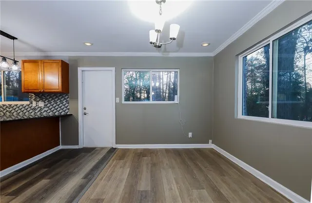 a view of room with wooden floor fireplace and window