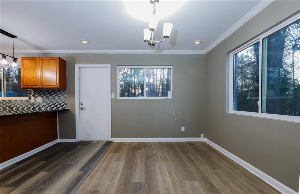 1277 Goodwin Road Northeast, Unit 1275 Atlanta, GA 30324 - Photo 5 of 19 a view of room with wooden floor fireplace and window