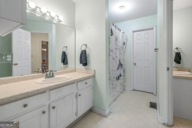 a spacious bathroom with double sink and shower