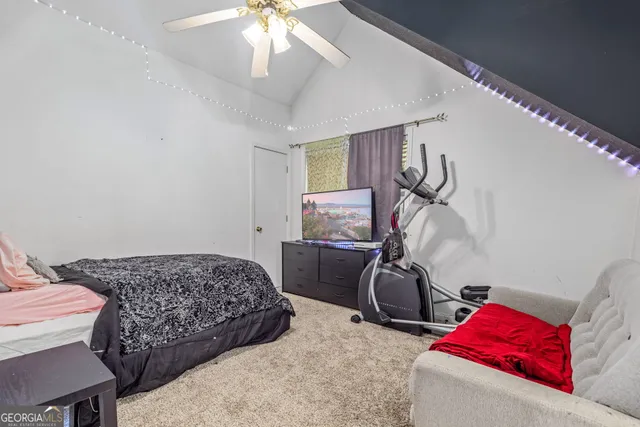 a bedroom with bed and a chandelier
