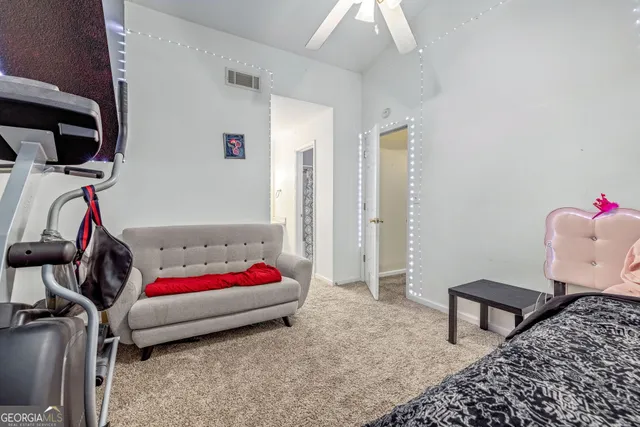 a bedroom with a bed and a chair