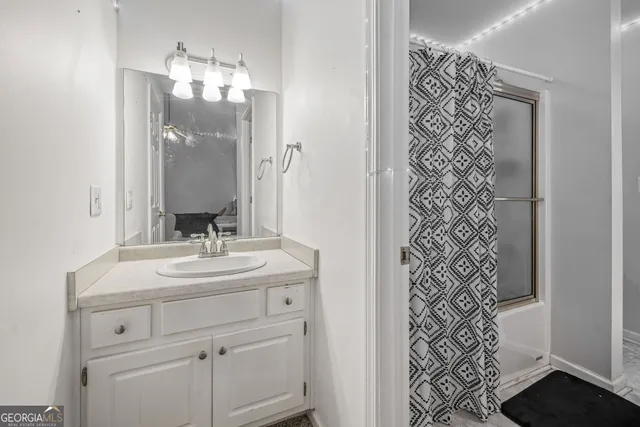 a bathroom with a sink a mirror and a shower