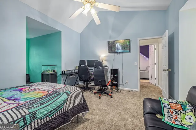 a bedroom that has a bed and a chair in it