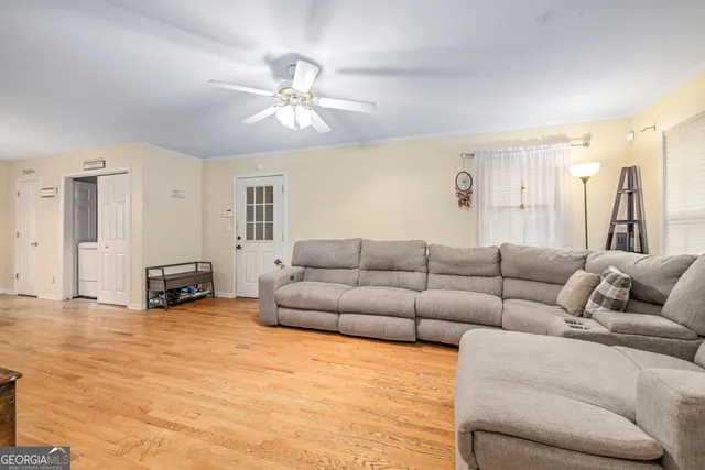 a living room with furniture and a flat screen tv