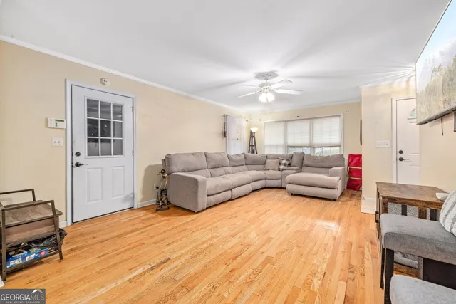 a living room with furniture and a wooden floor