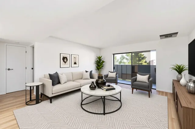 a living room with furniture rug and a large window
