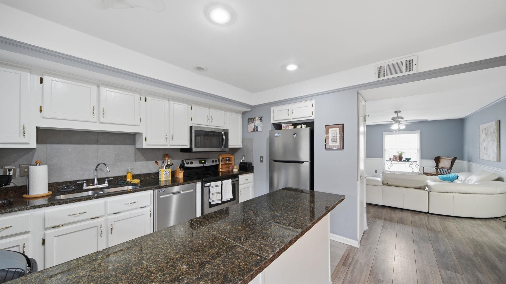 5866 Roxbury Drive, Unit 5866 Memphis, TN 38119 - Photo 8 of 20 Kitchen featuring white cabinetry, dark speckled countertops, and stainless steel appliances