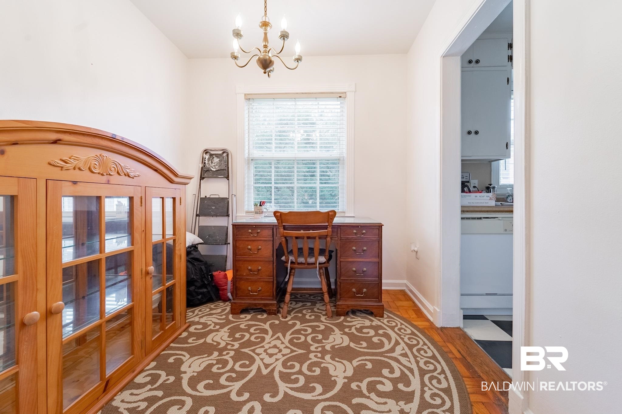 Office space featuring hardwood / wood-style floors and a notable chandelier