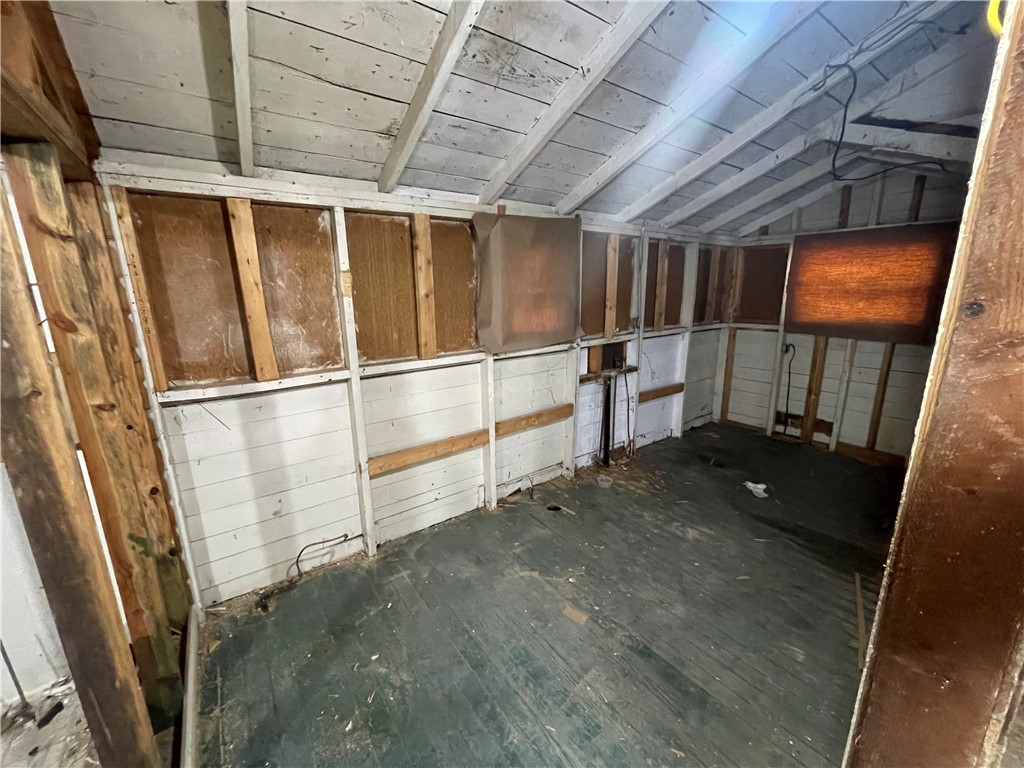 171 River Ridge Road Seneca, SC 29672 - Photo 12 of 22 A rustic utility space awaits transformation, featuring exposed wood beams and sturdy flooring.
