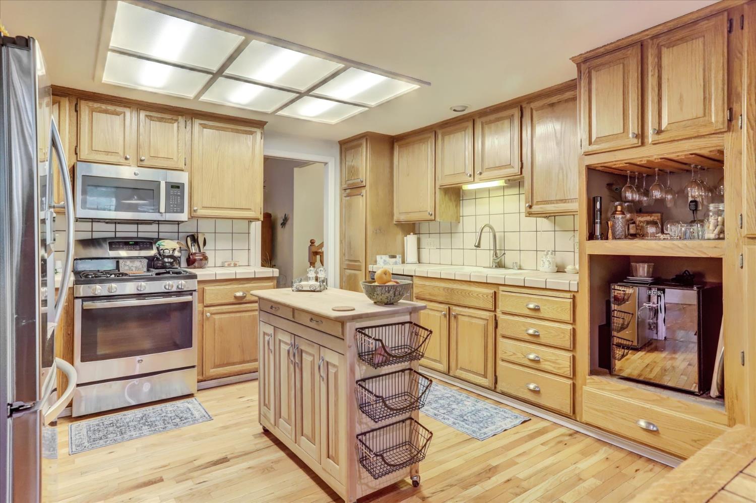 12746 Quaker Hill Cross Road Nevada City, CA 95959 - Photo 12 of 99 a kitchen with stainless steel appliances granite countertop a stove a sink and a refrigerator