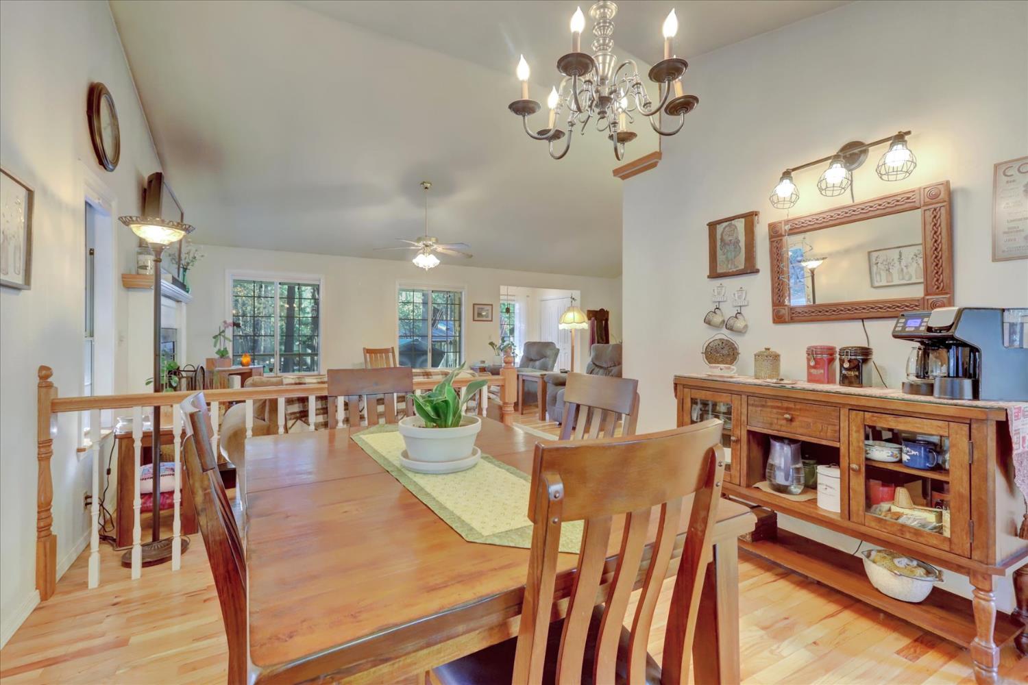 12746 Quaker Hill Cross Road Nevada City, CA 95959 - Photo 16 of 99 a view of a dining room with furniture and a chandelier