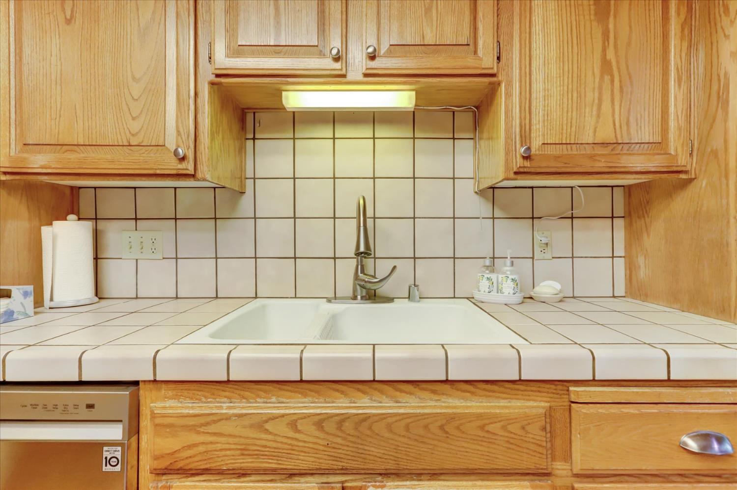 12746 Quaker Hill Cross Road Nevada City, CA 95959 - Photo 22 of 99 a bathroom with a granite countertop sink and a mirror