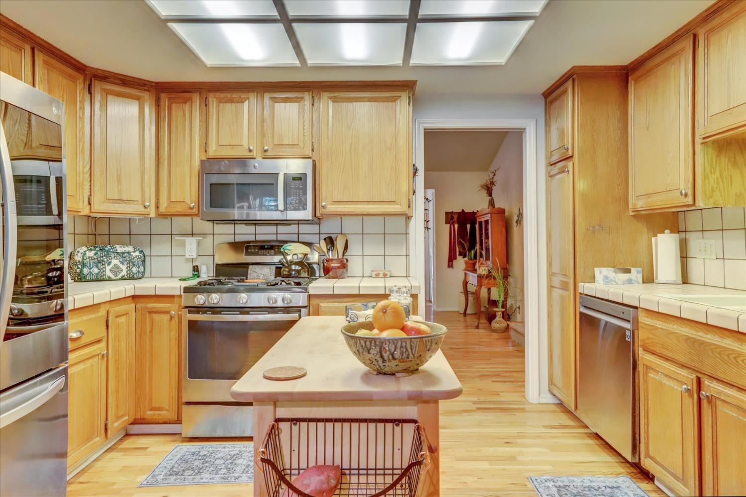 12746 Quaker Hill Cross Road Nevada City, CA 95959 - Photo 23 of 99 a kitchen with stainless steel appliances granite countertop a stove top oven a sink dishwasher and cabinets