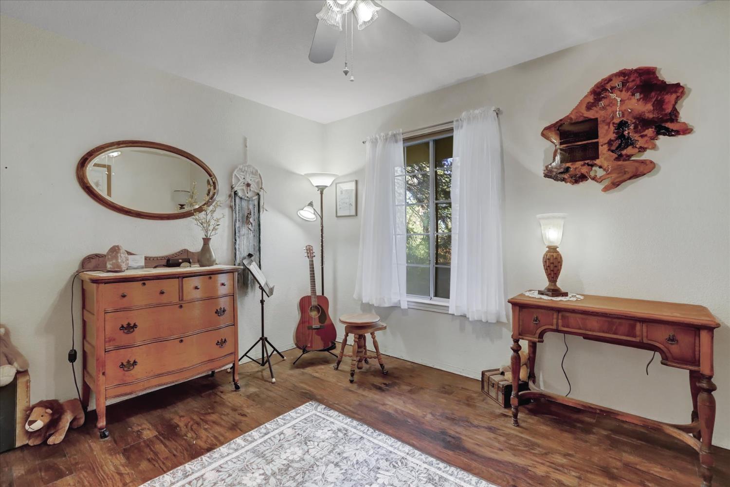 12746 Quaker Hill Cross Road Nevada City, CA 95959 - Photo 37 of 99 a bedroom with a bed and a chandelier