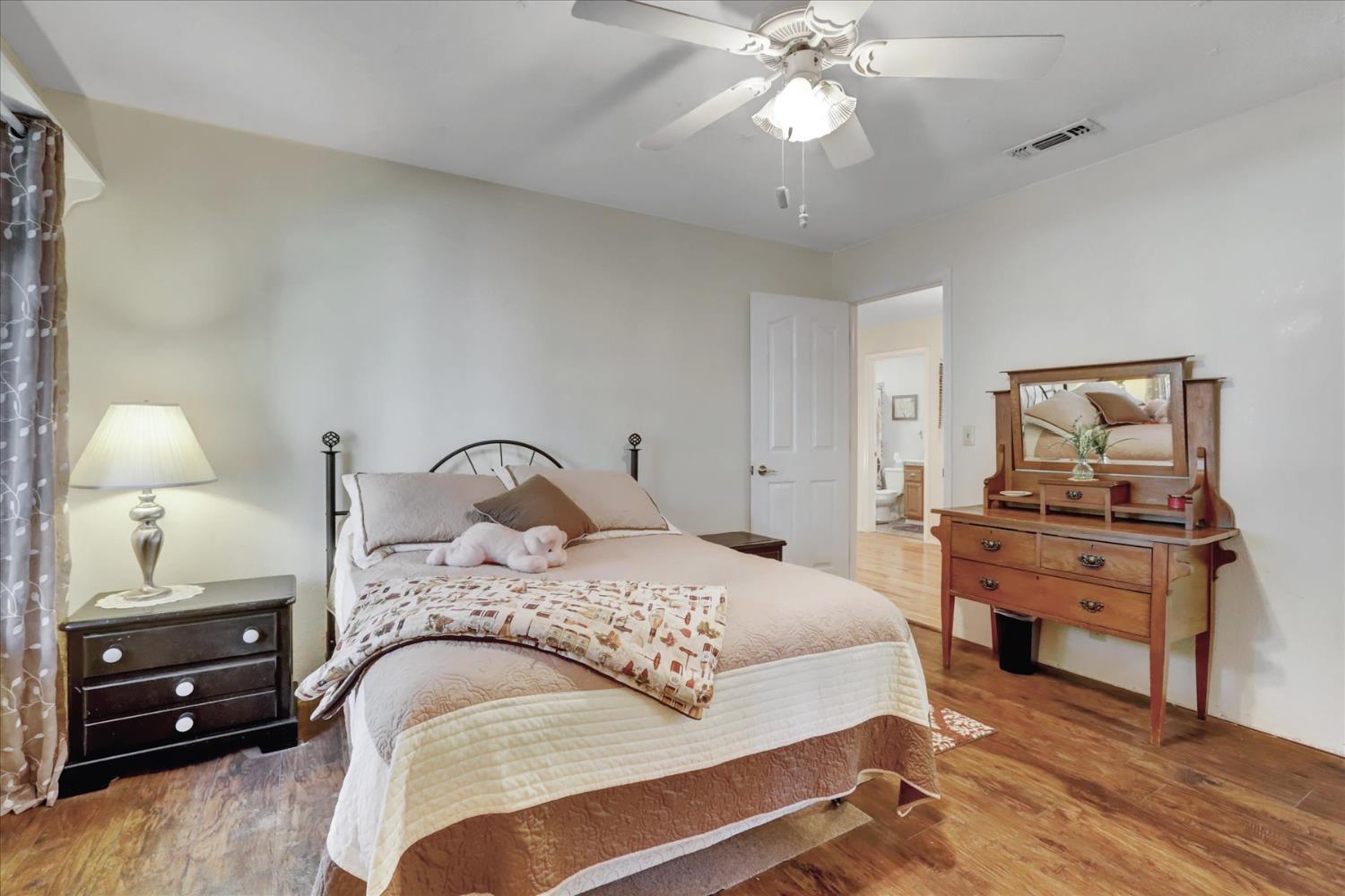 12746 Quaker Hill Cross Road Nevada City, CA 95959 - Photo 42 of 99 a bedroom with a bed and a chandelier