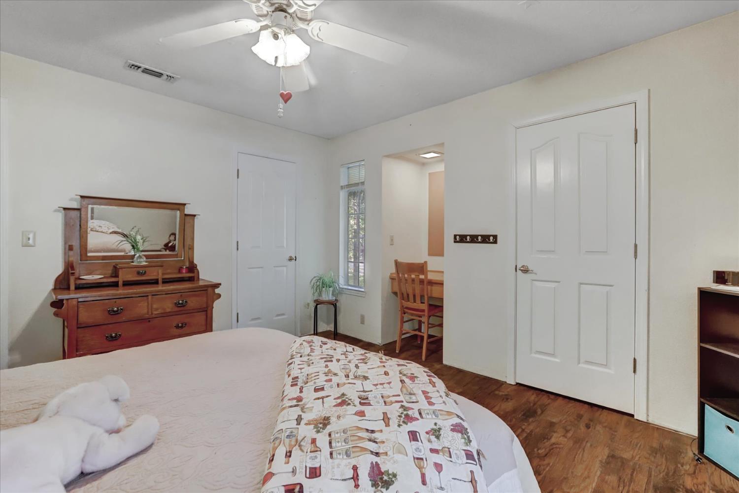 12746 Quaker Hill Cross Road Nevada City, CA 95959 - Photo 43 of 99 a bedroom with a bed and wooden floor
