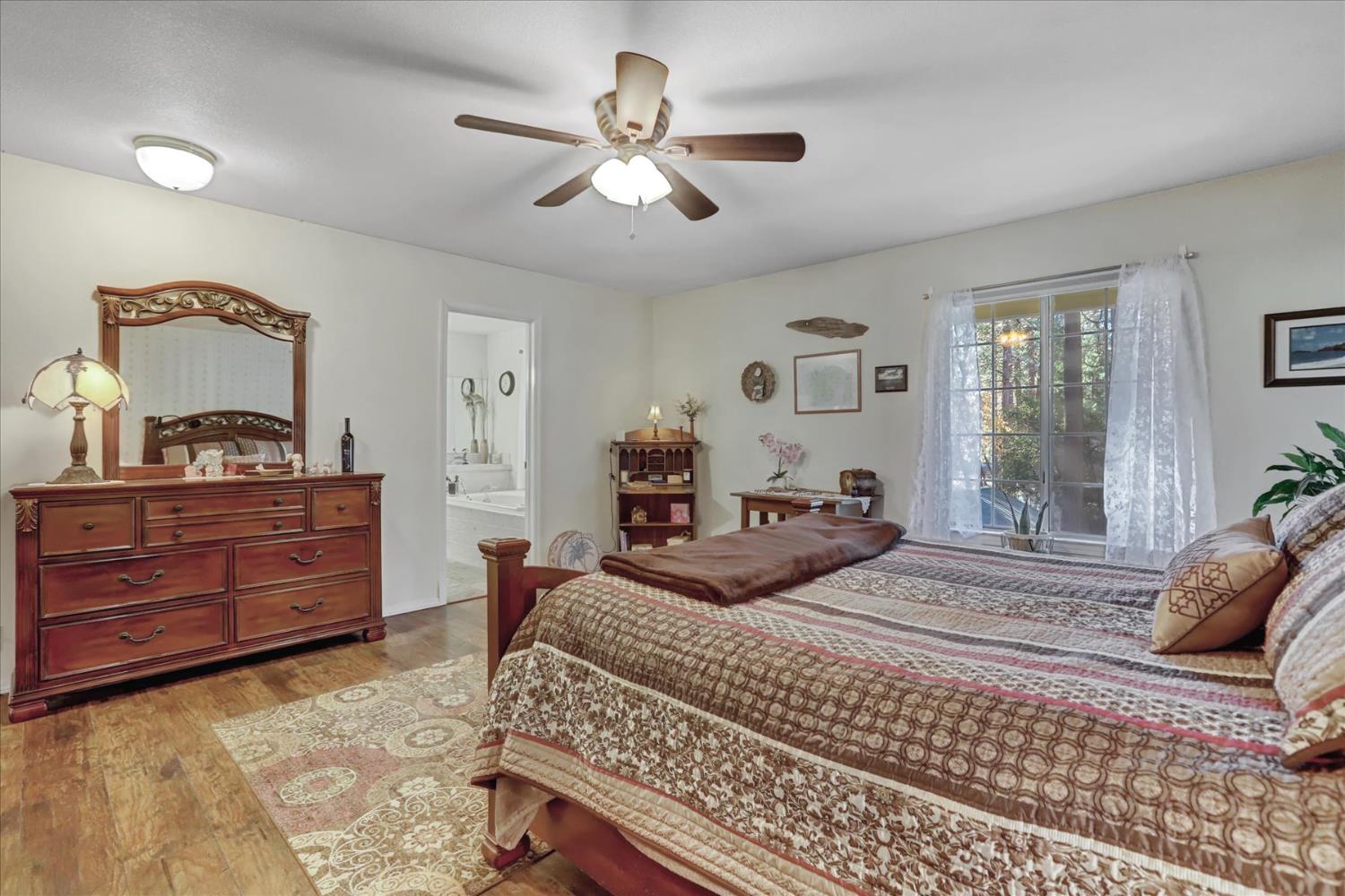 12746 Quaker Hill Cross Road Nevada City, CA 95959 - Photo 46 of 99 a bedroom with a bed and wooden floor