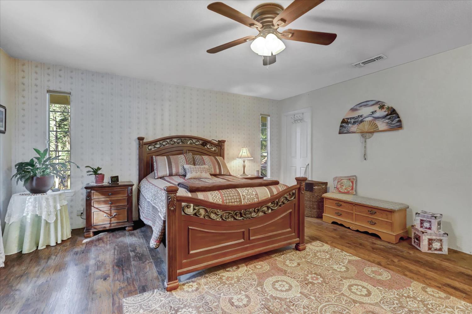 12746 Quaker Hill Cross Road Nevada City, CA 95959 - Photo 47 of 99 a bedroom with a bed and a chandelier