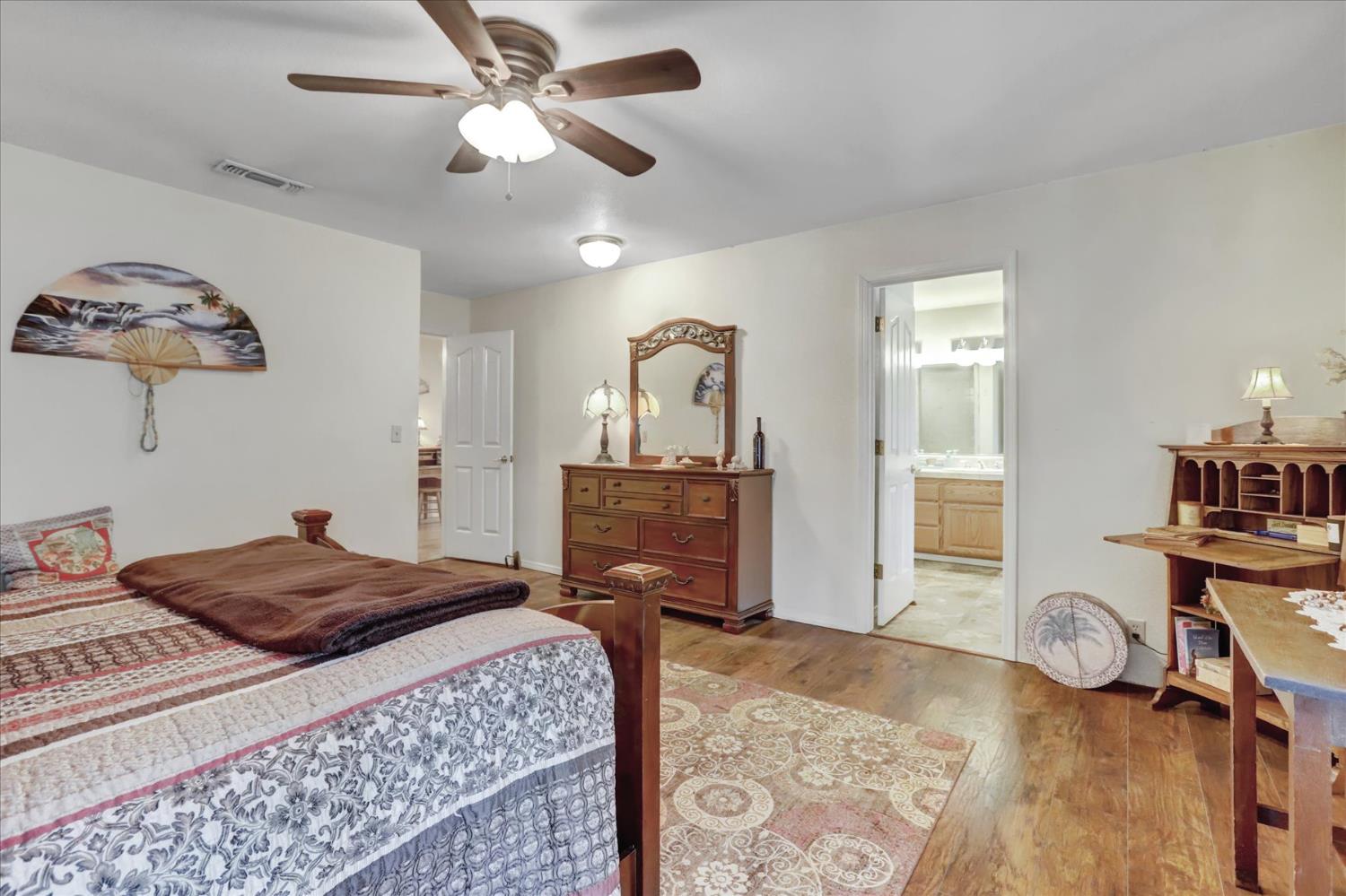 12746 Quaker Hill Cross Road Nevada City, CA 95959 - Photo 48 of 99 a bedroom with a bed and wooden floor
