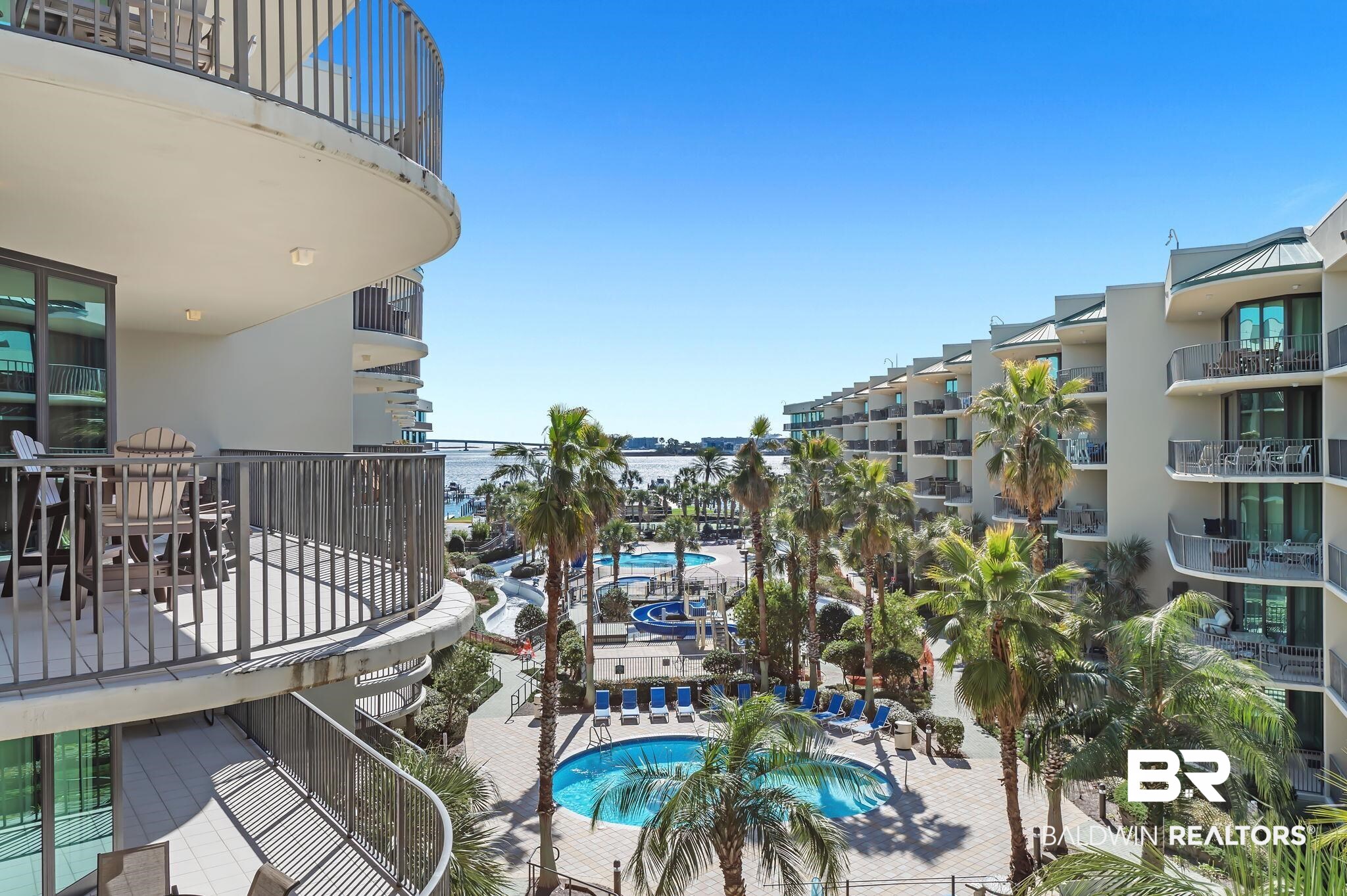 27580 Canal Road, Unit 1112 Orange Beach, AL 36561 - Photo 46 of 50 Community pool with a balcony, a water view, and a patio area