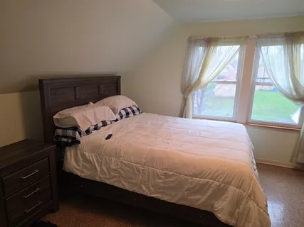 a bedroom with a bed and window