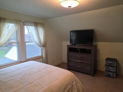 a bedroom with a bed and a television