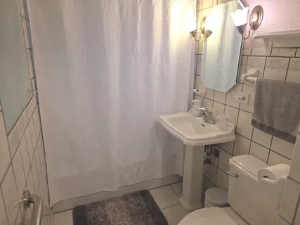 a bathroom with a sink toilet and mirror