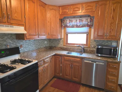 a kitchen with a stove a sink and a microwave