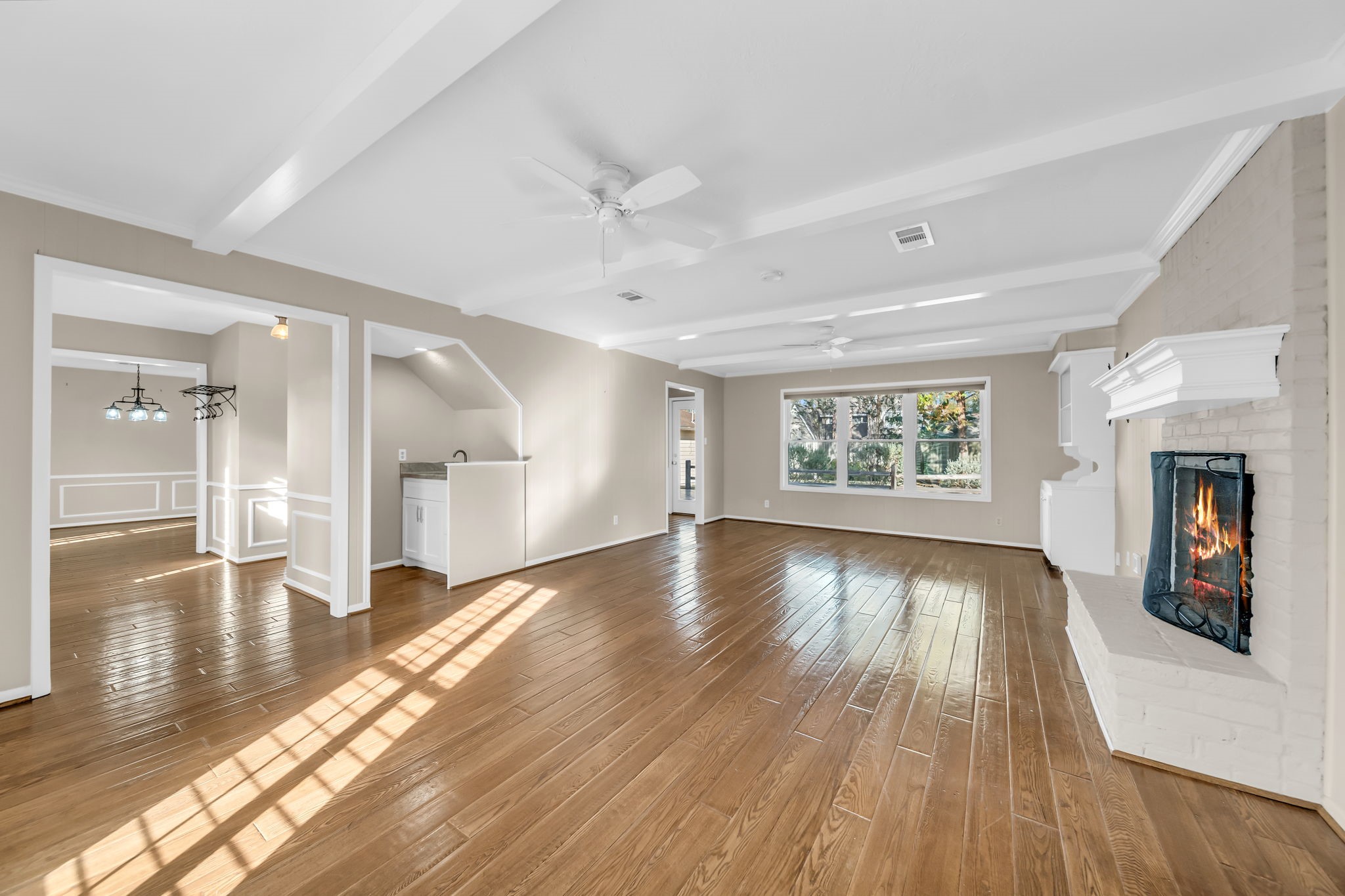 115 Heather Lane Conroe, TX 77385 - Photo 2 of 28 wooden floor in an empty room with a window